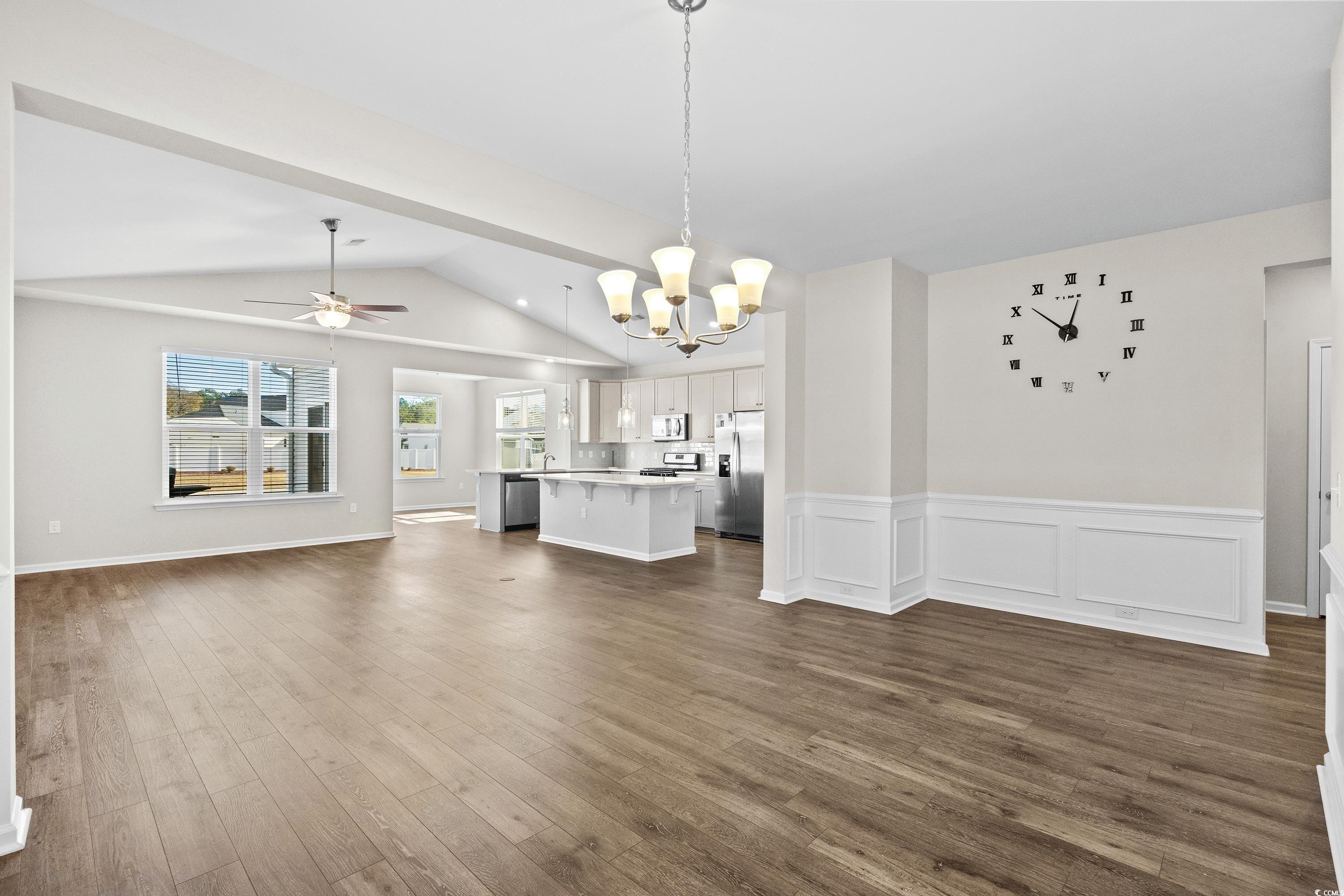 Unfurnished living room featuring sink, ceiling fa