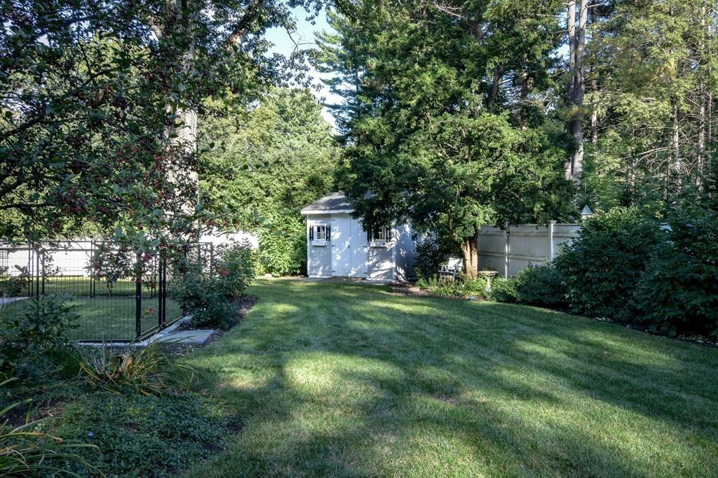 34 Lowell Road Wellesley, MA 02481 - Photo 14 of 14 a backyard of a house with plants and large trees