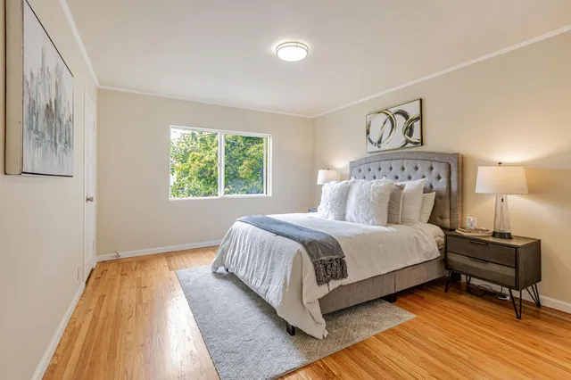 a bedroom with a bed and a night stand