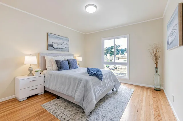 a bedroom with a bed and a large window