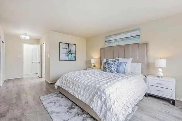 a bedroom with a bed and a night stand