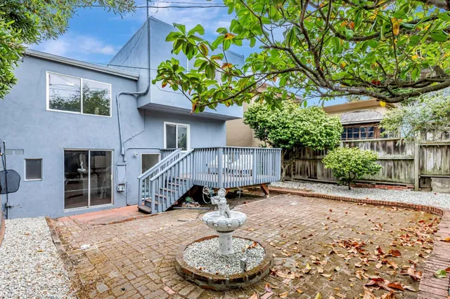 a backyard of a house with table and chairs