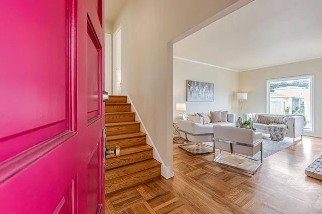 a living room with furniture and a stairs