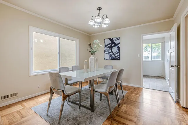 a view of a dining room with furniture and wooden floor
