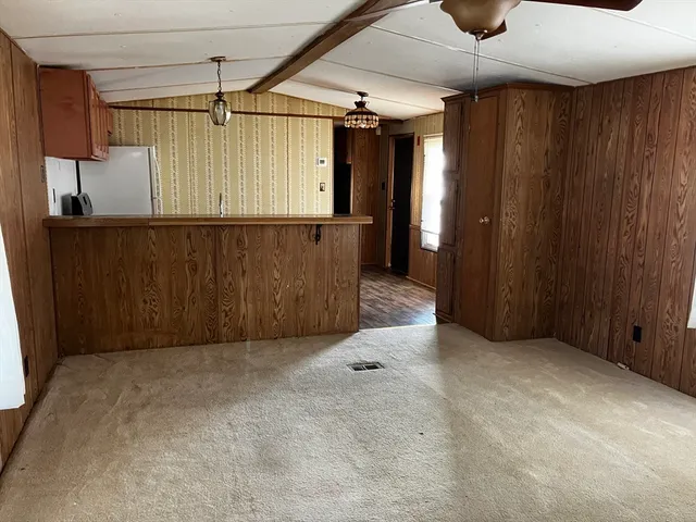 a kitchen with granite countertop a refrigerator stove and sink