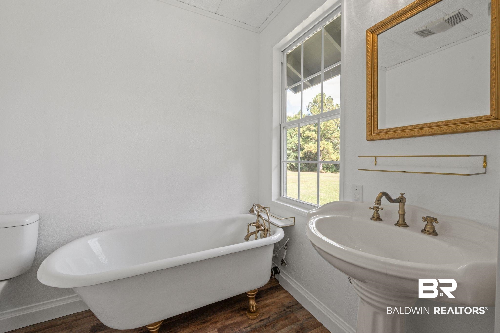 20037 County Road 33 Fairhope, AL 36532 - Photo 54 of 79 Bathroom featuring a bathtub, toilet, sink, and hardwood / wood-style floors