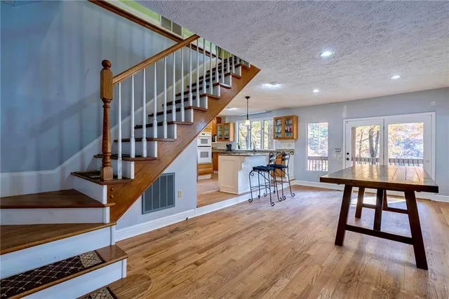 a view of entryway dining room and hall with wooden floor