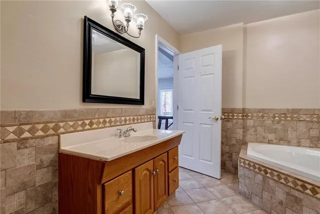 a bathroom with a sink a vanity and a mirror