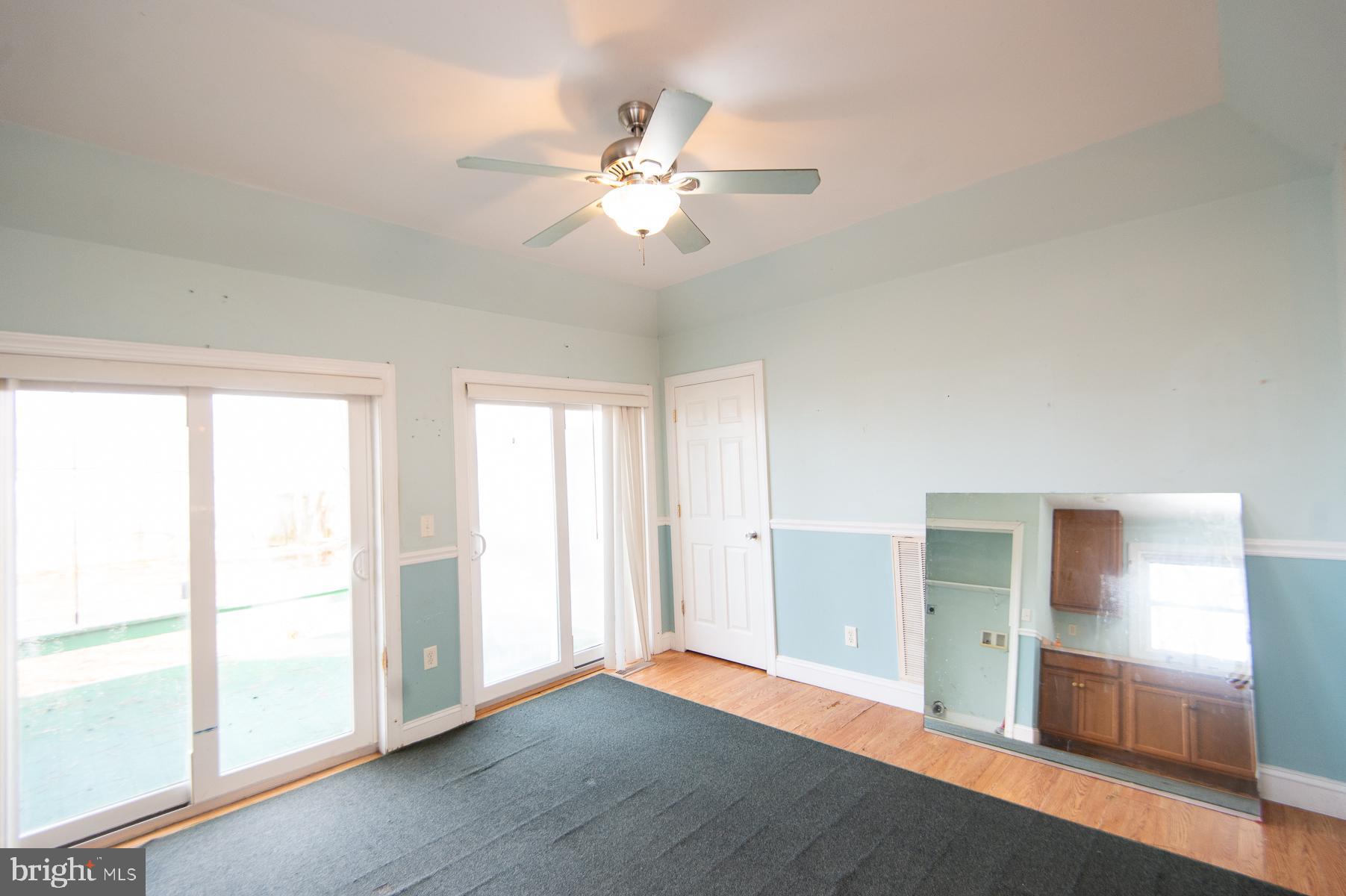 1210 Stone Boundary Road Cambridge, MD 21613 - Photo 11 of 63 a view of an empty room with window and wooden floor