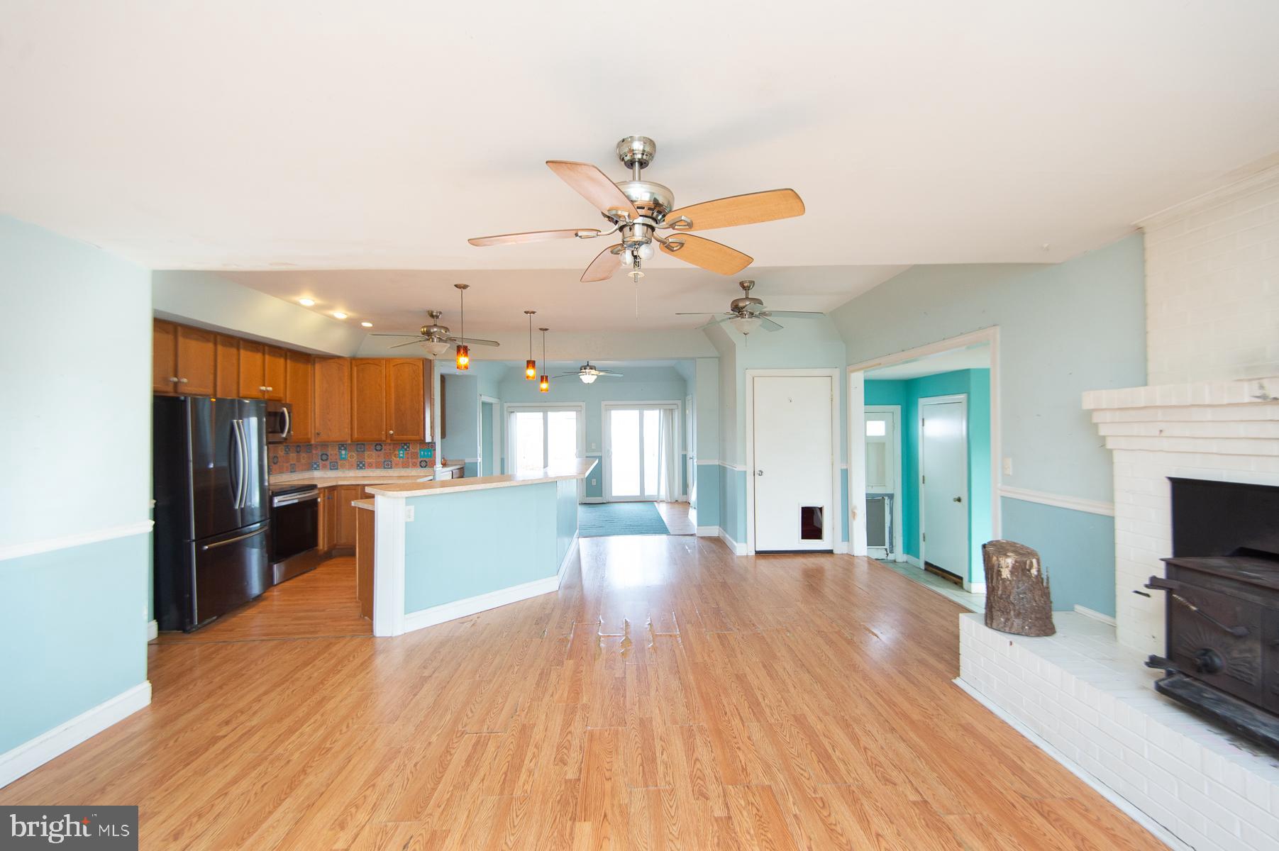 1210 Stone Boundary Road Cambridge, MD 21613 - Photo 3 of 63 a view of a kitchen and dining room with wooden floor