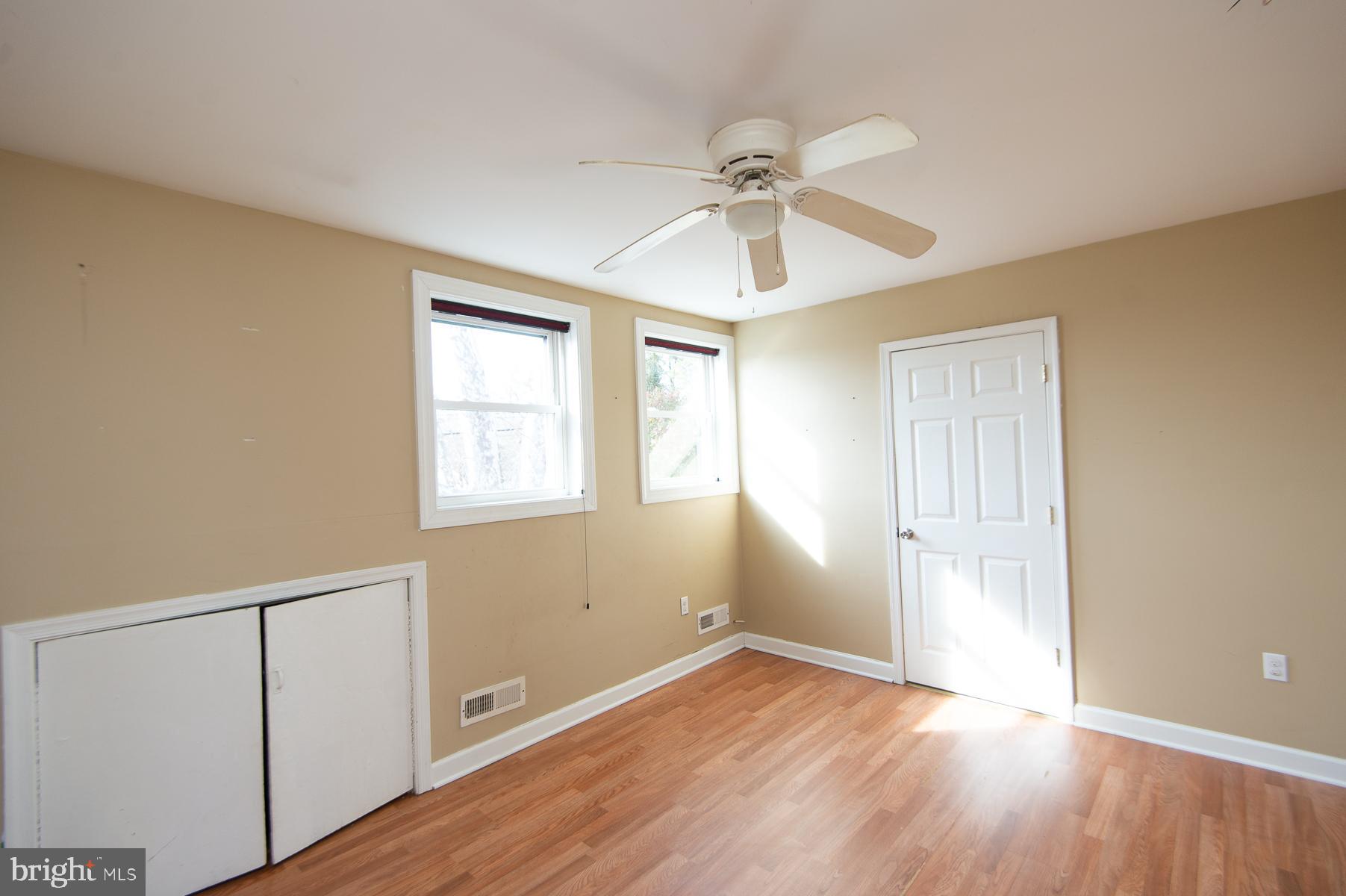 1210 Stone Boundary Road Cambridge, MD 21613 - Photo 44 of 63 a view of an empty room with wooden floor and a window