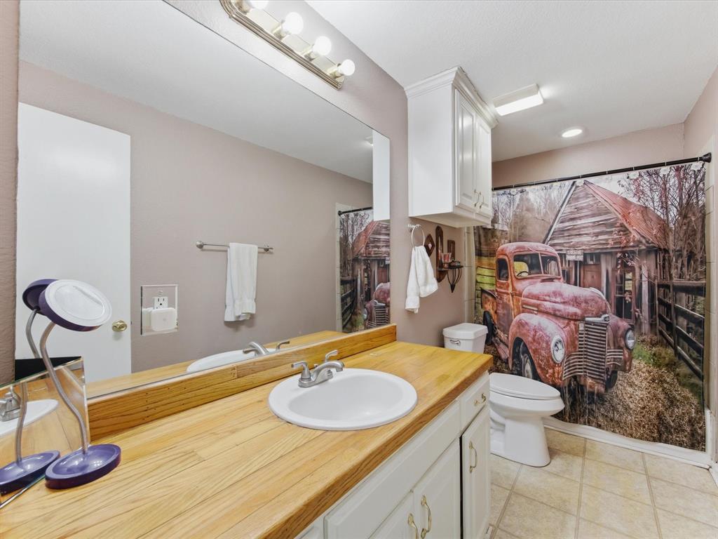 301 Ovilla Road Waxahachie, TX 75167 - Photo 22 of 38 a bathroom with a sink and a mirror