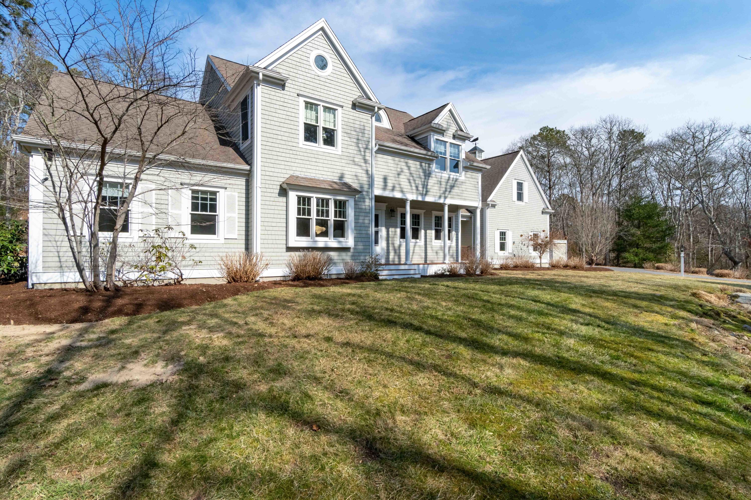 a front view of a house with a garden