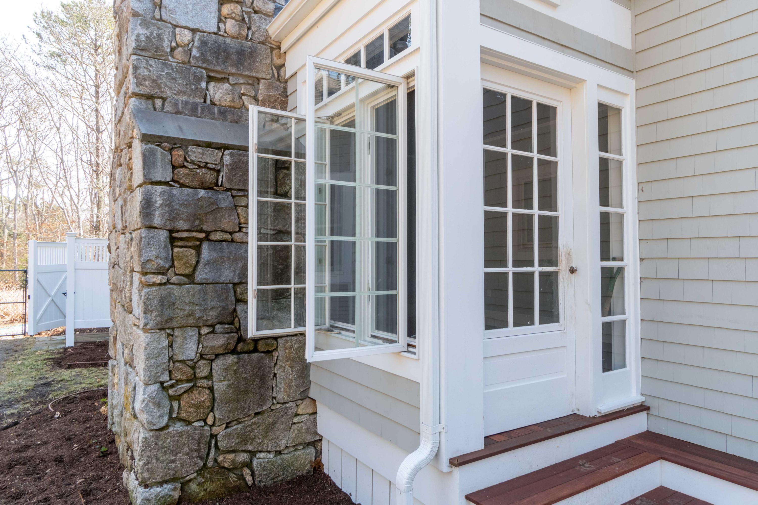 5 Pasture Road Cataumet, MA 02534 - Photo 37 of 52 a front view of a house with a glass door