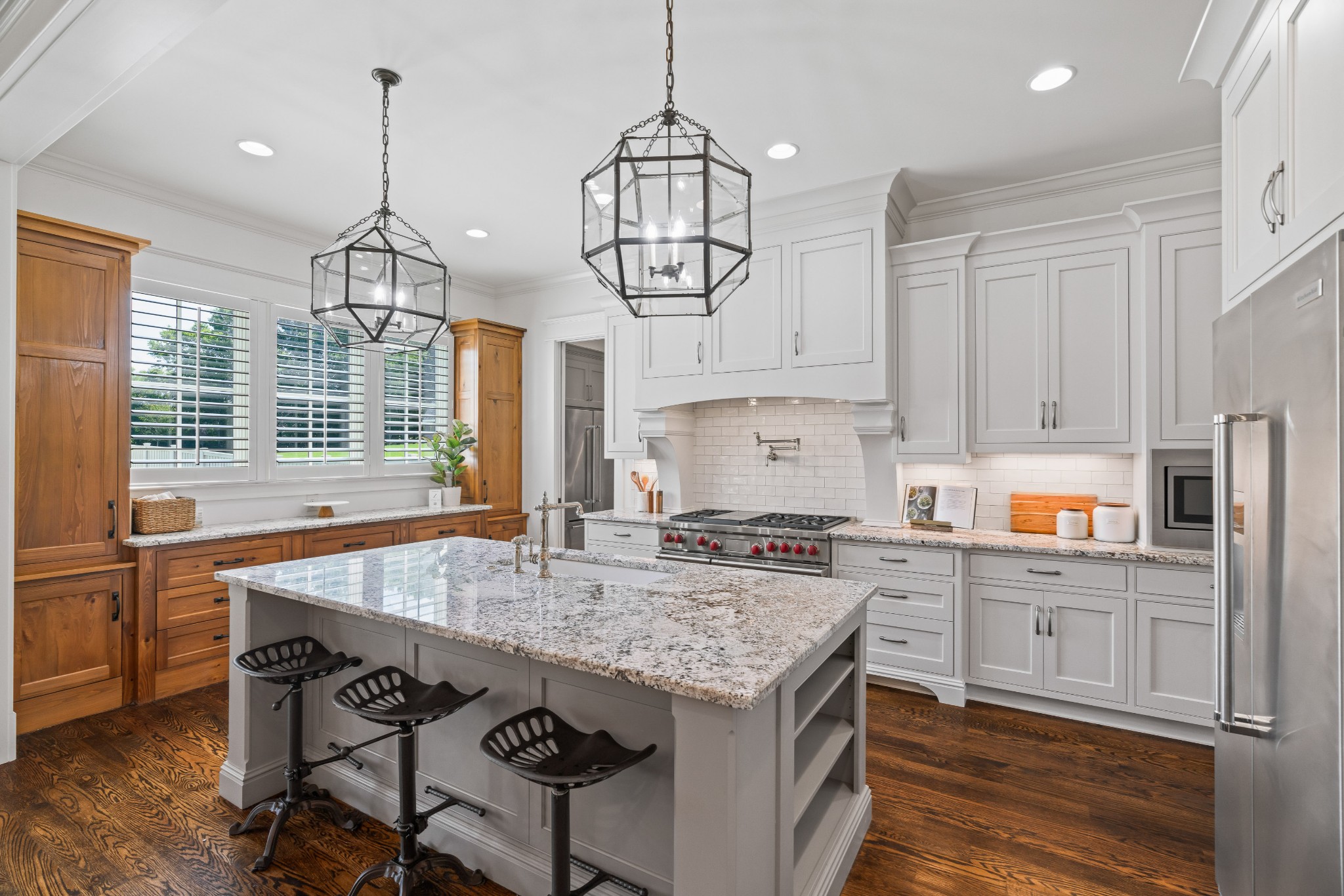 4108 Trinity Road College Grove, TN 37046 - Photo 28 of 70 a kitchen with kitchen island granite countertop a stove a sink a center island and wooden floor