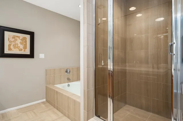 a bathroom with a bathtub and shower