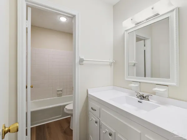 a bathroom with a bathtub a sink a vanity and a mirror