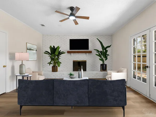 a living room with furniture fireplace and potted plant