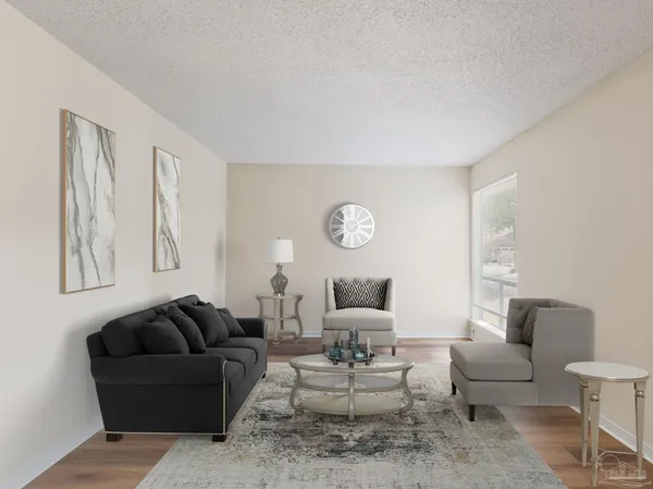 a living room with furniture a rug and a lamp