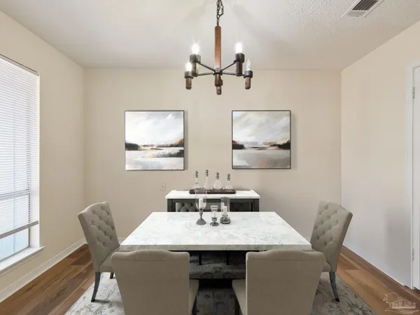a dining room with furniture and wooden floor