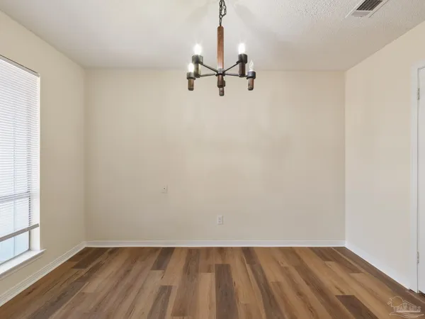 a view of a room with wooden floor closet and windows