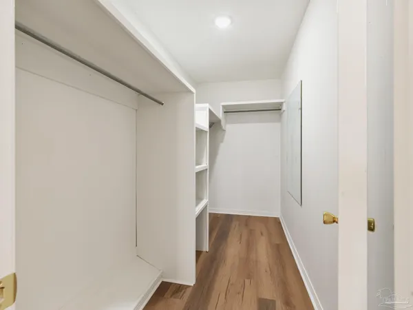 a view of hallway with wooden floor
