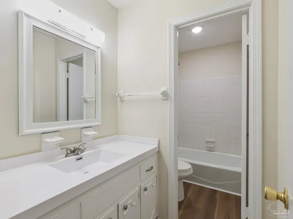 a bathroom with a bathtub shower sink vanity and a mirror