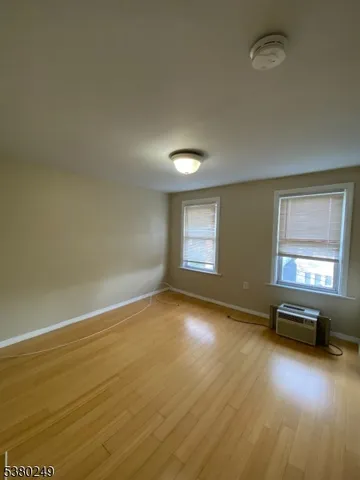a view of a livingroom with wooden floor and a window