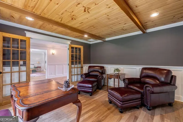 a living room with furniture and kitchen view