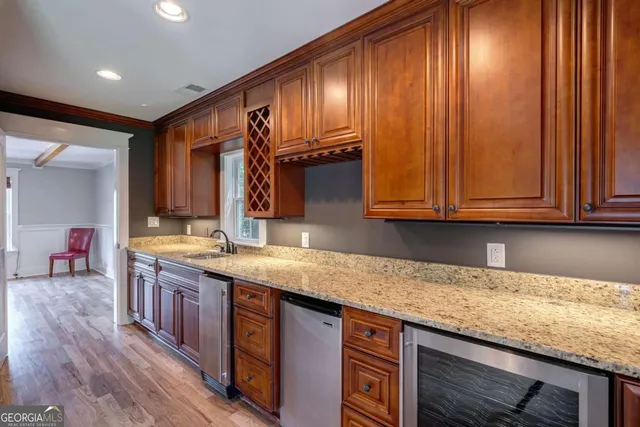 a kitchen with kitchen island wooden floors white appliances and white cabinets
