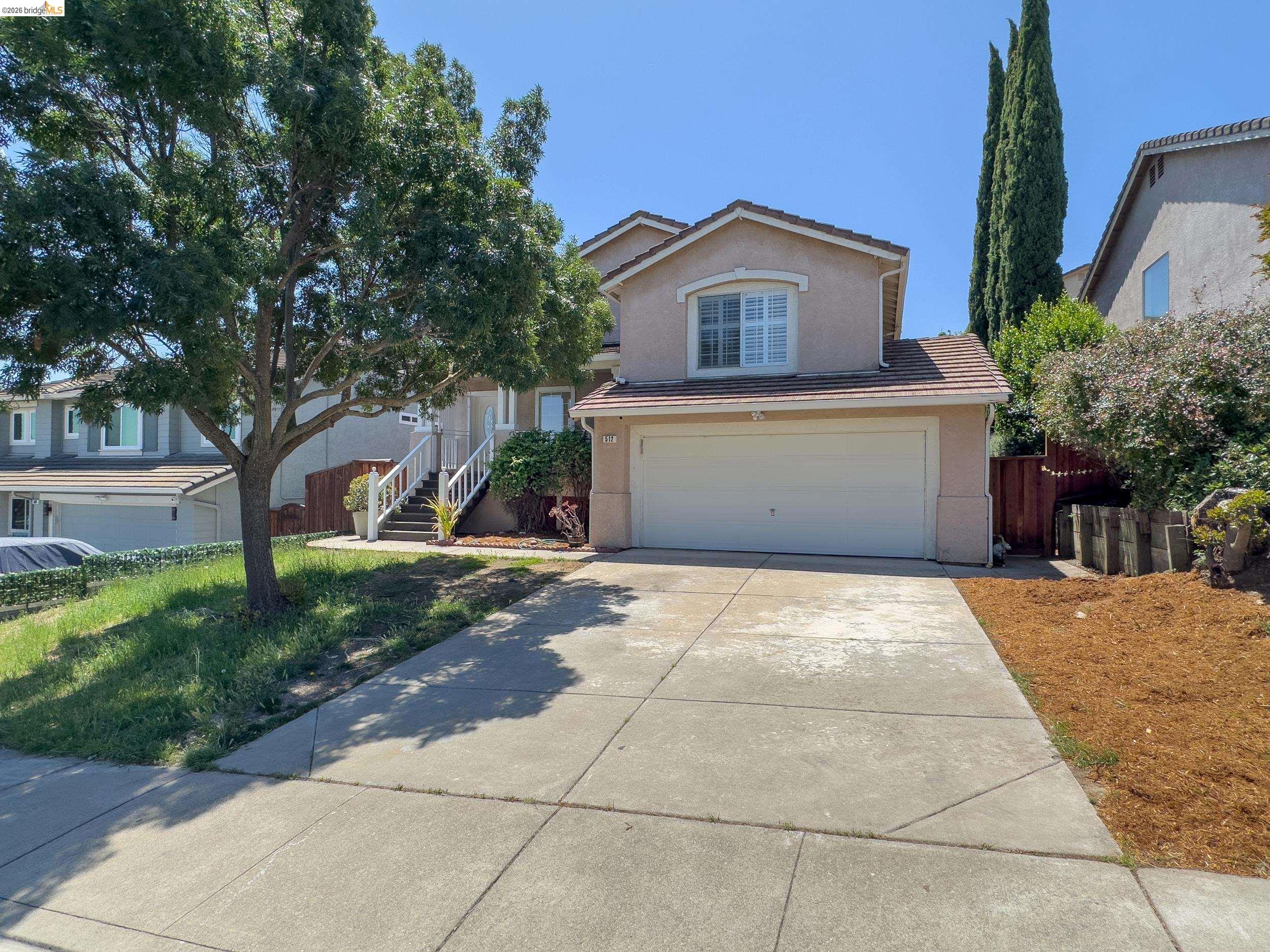 512 Burdick Drive Bay Point, CA 94565 - Photo 2 of 50 Two-story residence featuring a two-car garage, concrete driveway, and stucco exterior