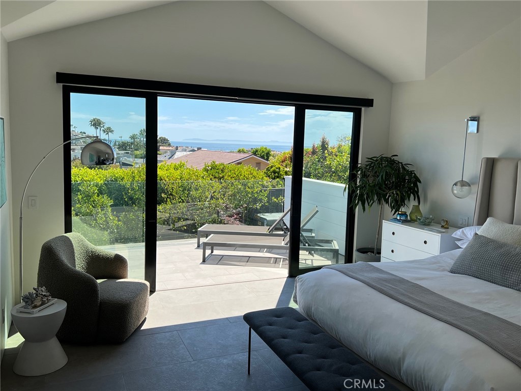 809 Emerald Bay Laguna Beach, CA 92651 - Photo 13 of 20 a bedroom with furniture and a large window