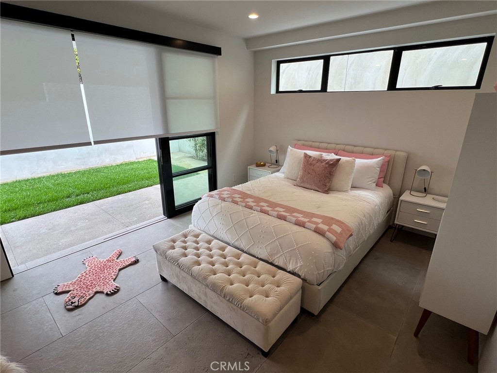 809 Emerald Bay Laguna Beach, CA 92651 - Photo 18 of 20 a bedroom with a bed painting on wall and a window