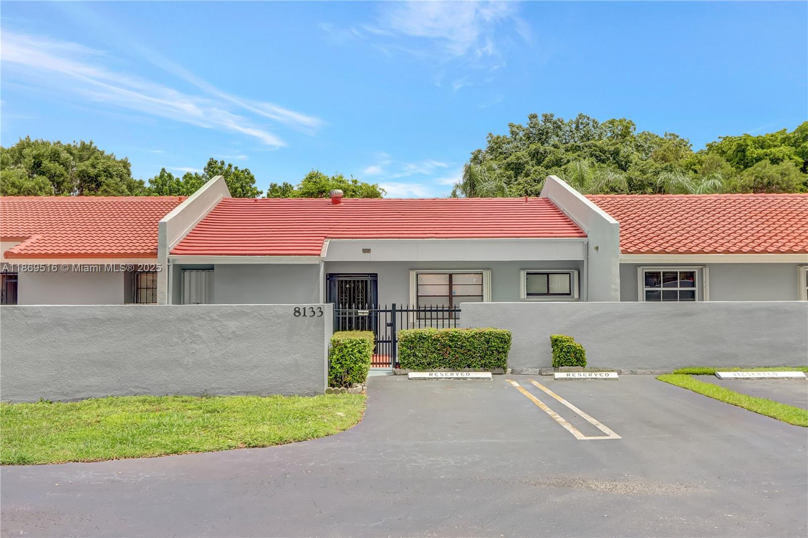 8133 Southwest 152nd Court Miami, FL 33193 - Photo 1 of 20 a front view of a house with a garden and yard