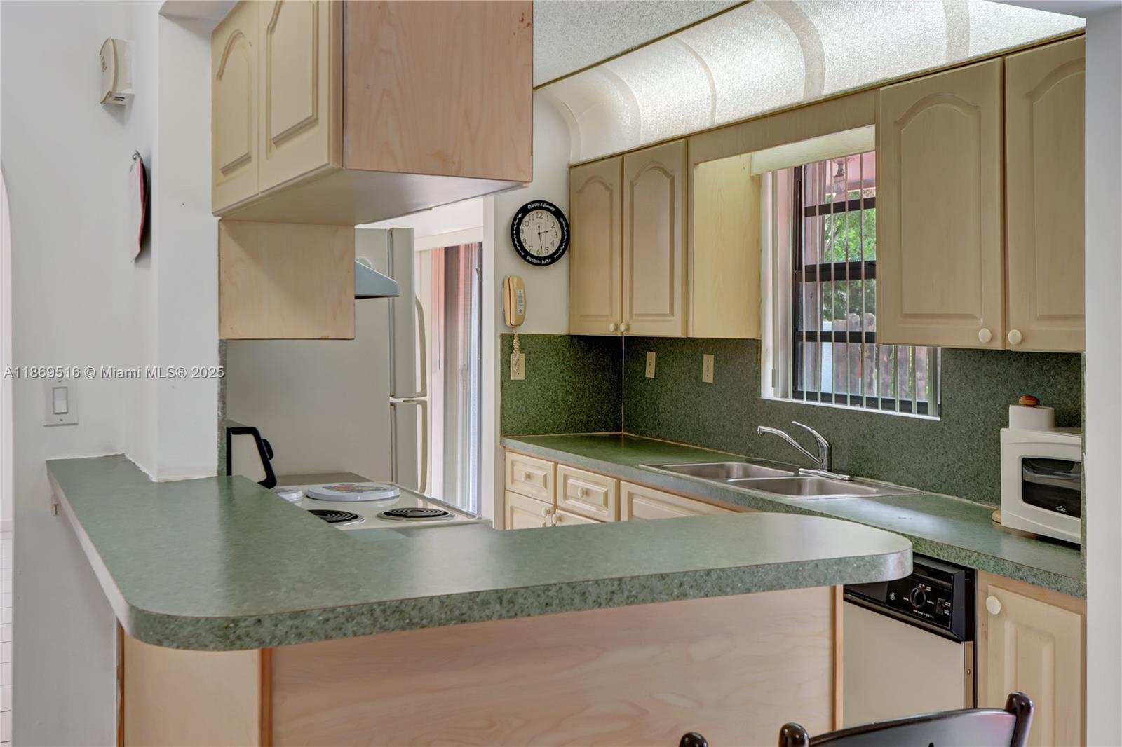 8133 Southwest 152nd Court Miami, FL 33193 - Photo 15 of 20 a kitchen with granite countertop a sink a counter top space cabinets and stainless steel appliances