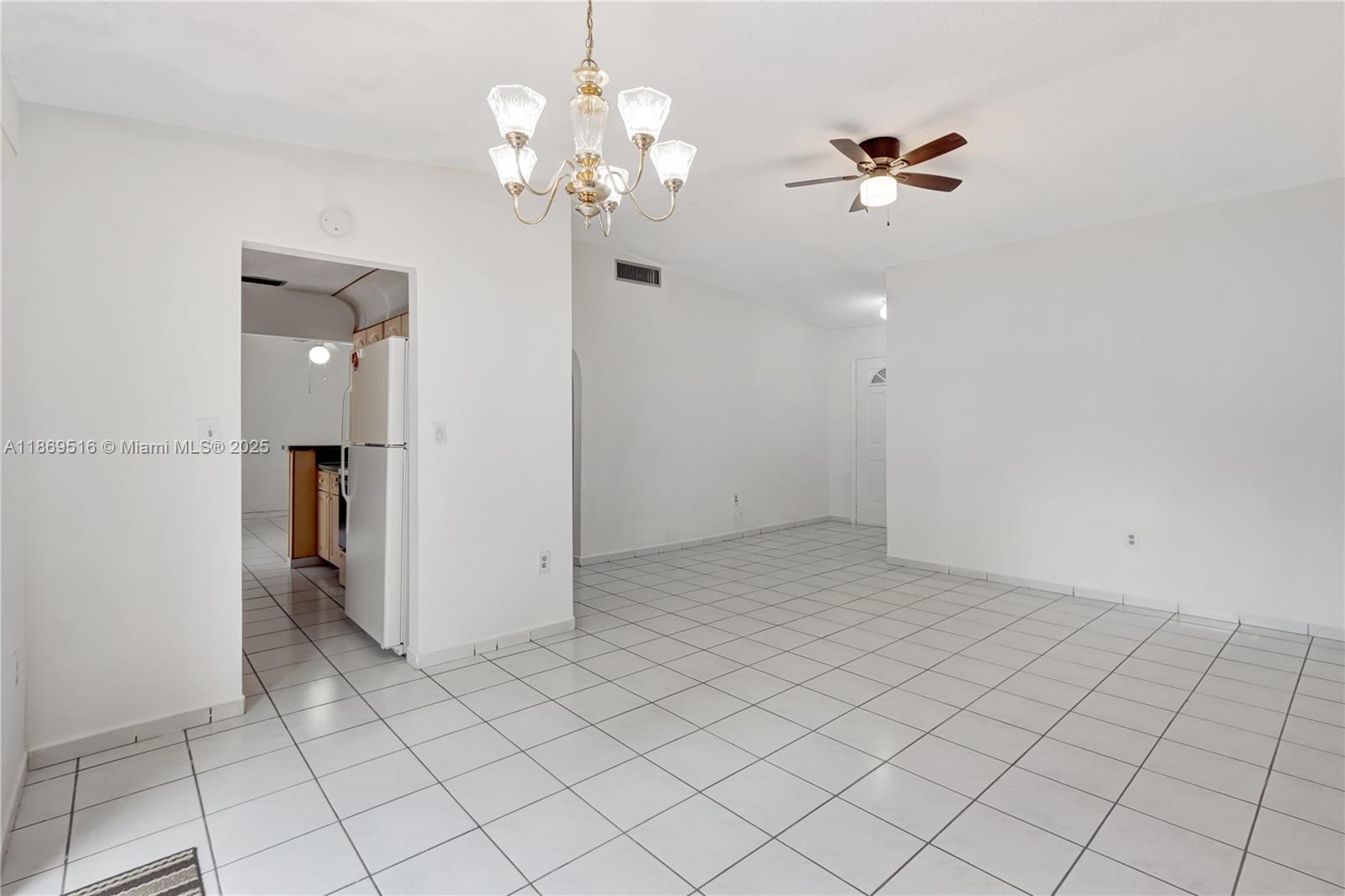 8133 Southwest 152nd Court Miami, FL 33193 - Photo 8 of 20 an empty room with chandelier fan