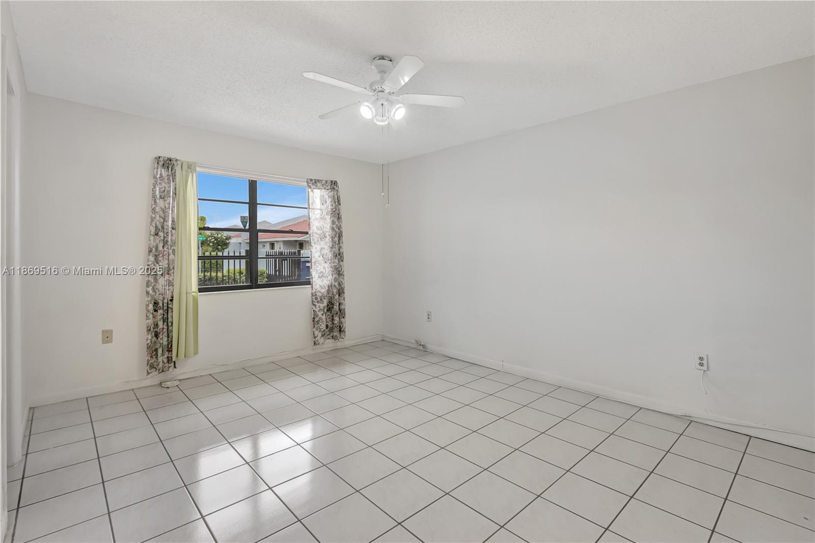 8133 Southwest 152nd Court Miami, FL 33193 - Photo 9 of 20 a view of an empty room and window
