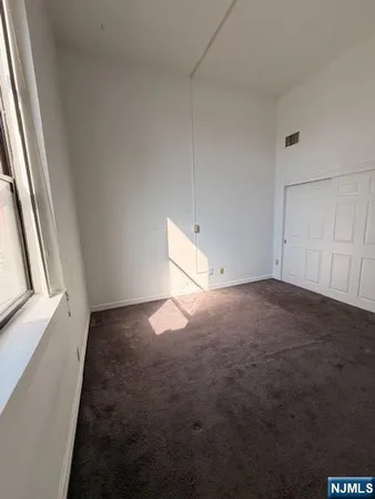 a view of a kitchen from the hallway