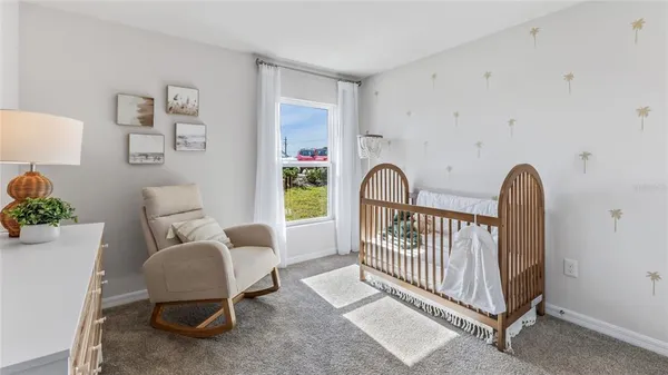 a bedroom with furniture and a chair