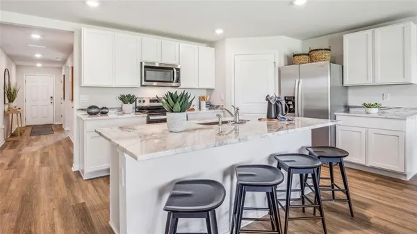 a kitchen with granite countertop kitchen island cabinets and refrigerator