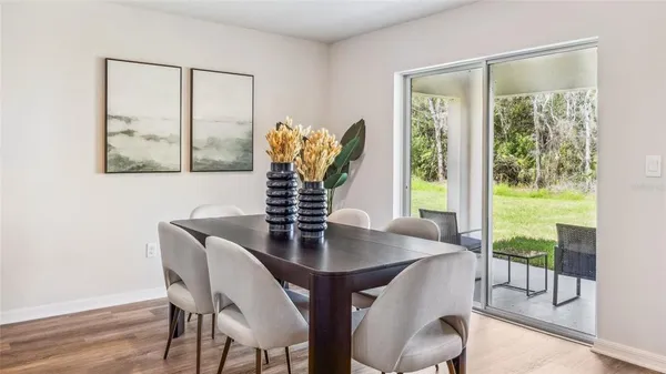 a view of a dining room with furniture window and wooden floor