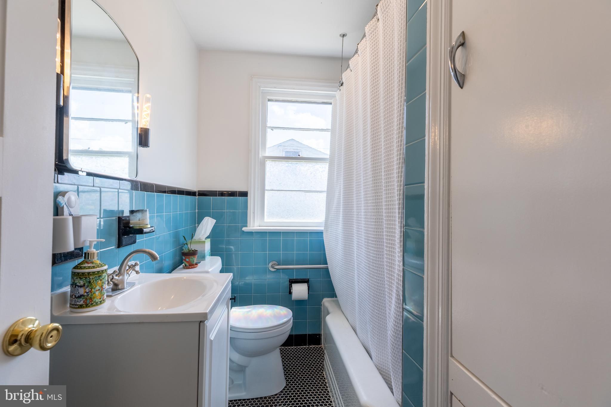 5 Lehigh Road Wilmington, DE 19808 - Photo 11 of 17 a bathroom with a sink a toilet and a shower curtain