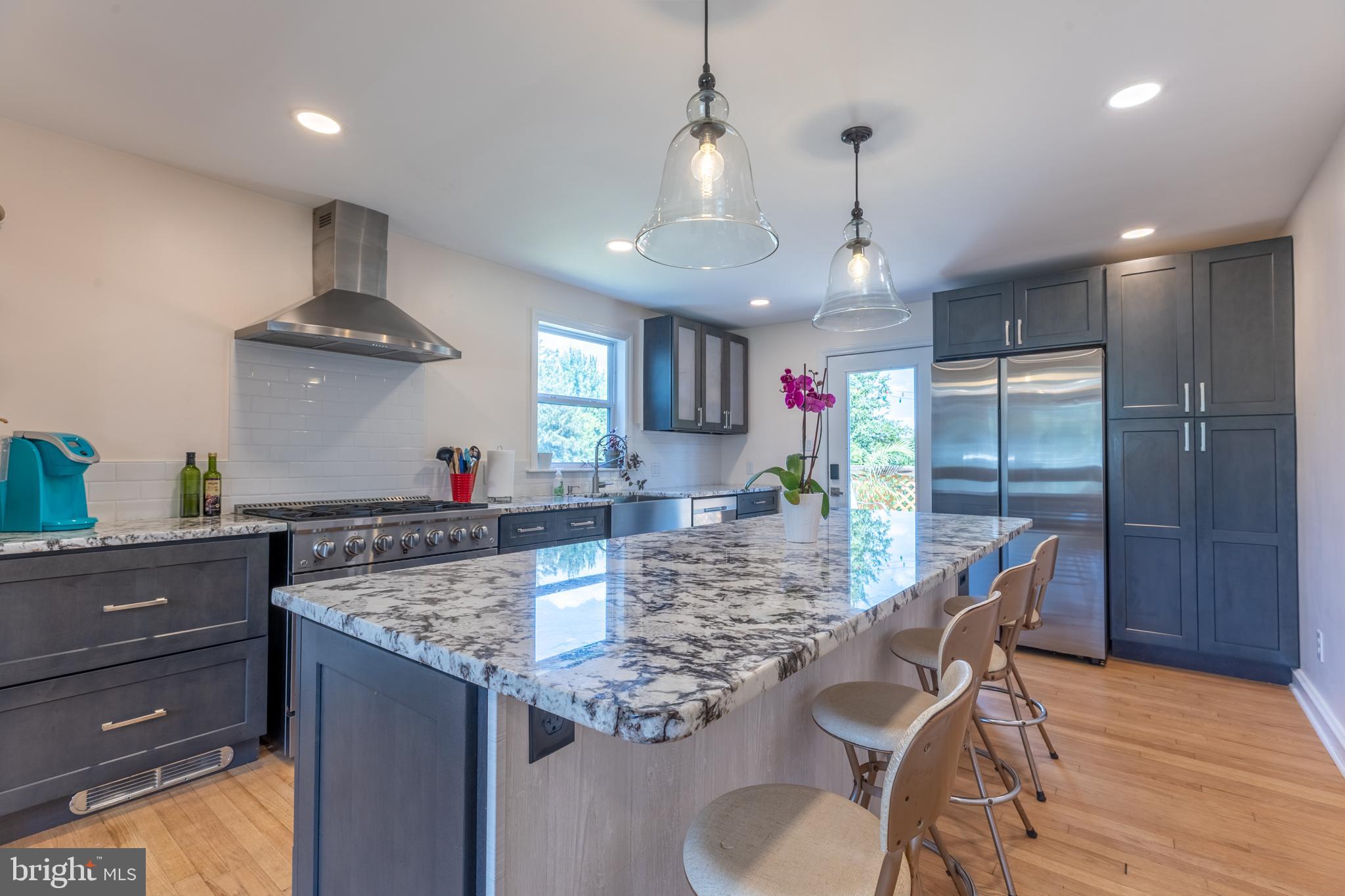 5 Lehigh Road Wilmington, DE 19808 - Photo 5 of 17 a kitchen with stainless steel appliances granite countertop a sink stove and refrigerator