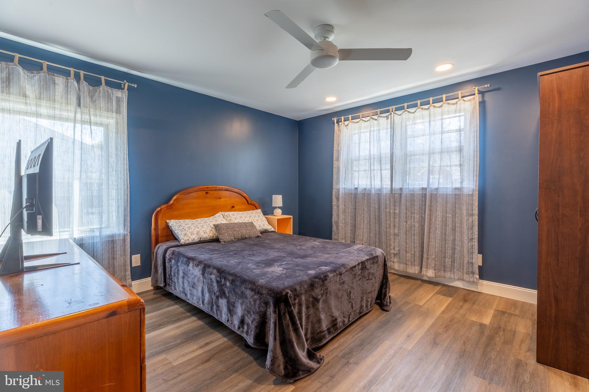 5 Lehigh Road Wilmington, DE 19808 - Photo 8 of 17 a bedroom with a bed window and a wooden floor