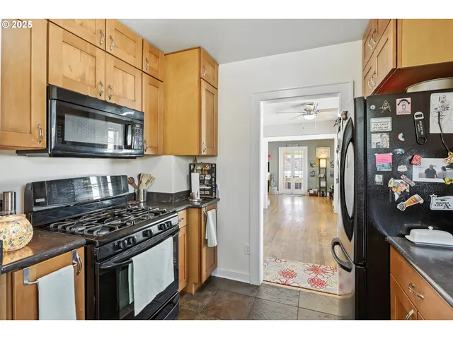 a kitchen with stainless steel appliances granite countertop a stove and a sink