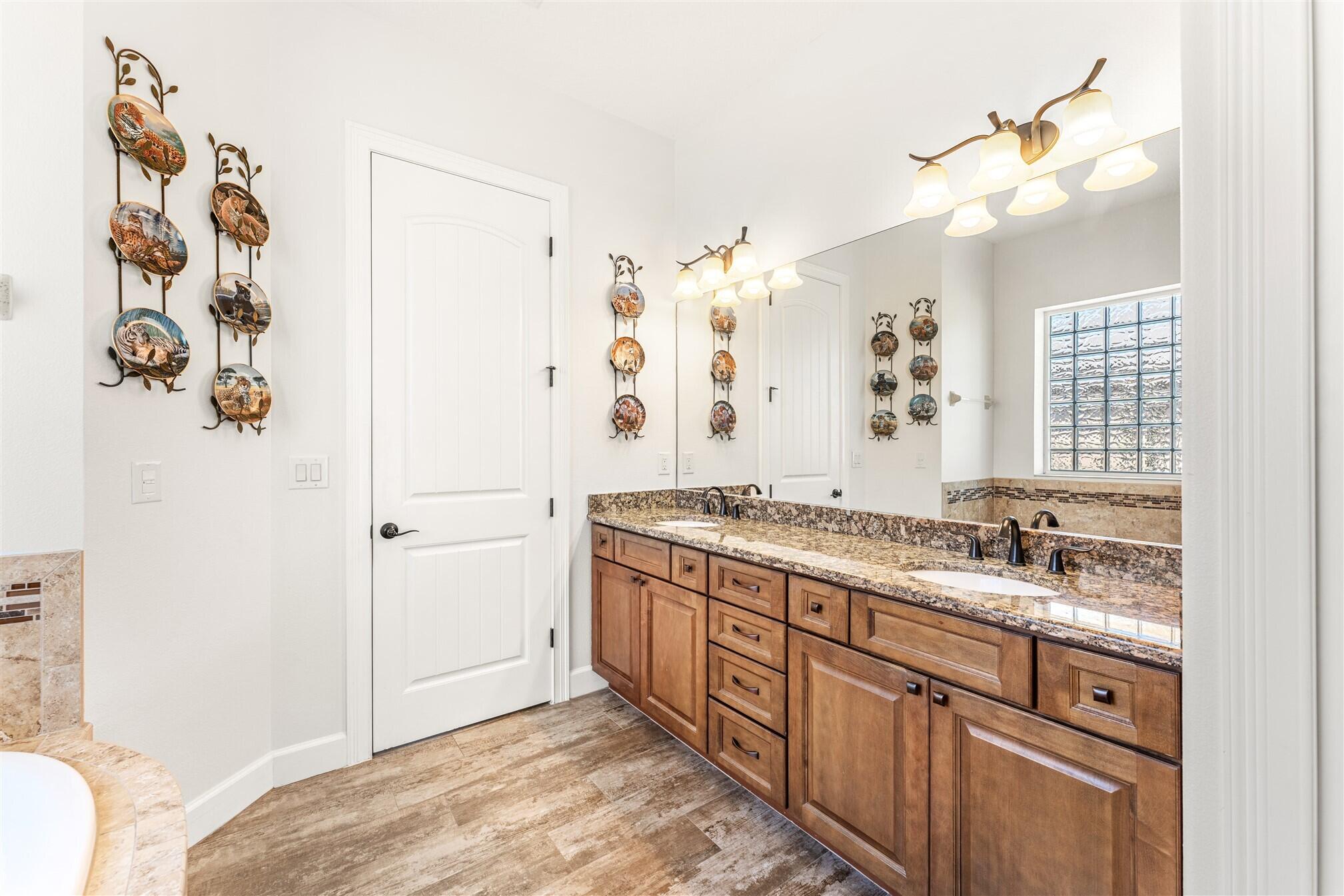 3210 Levanto Drive Melbourne, FL 32940 - Photo 24 of 76 a spacious bathroom with a granite countertop sink a mirror and a shower