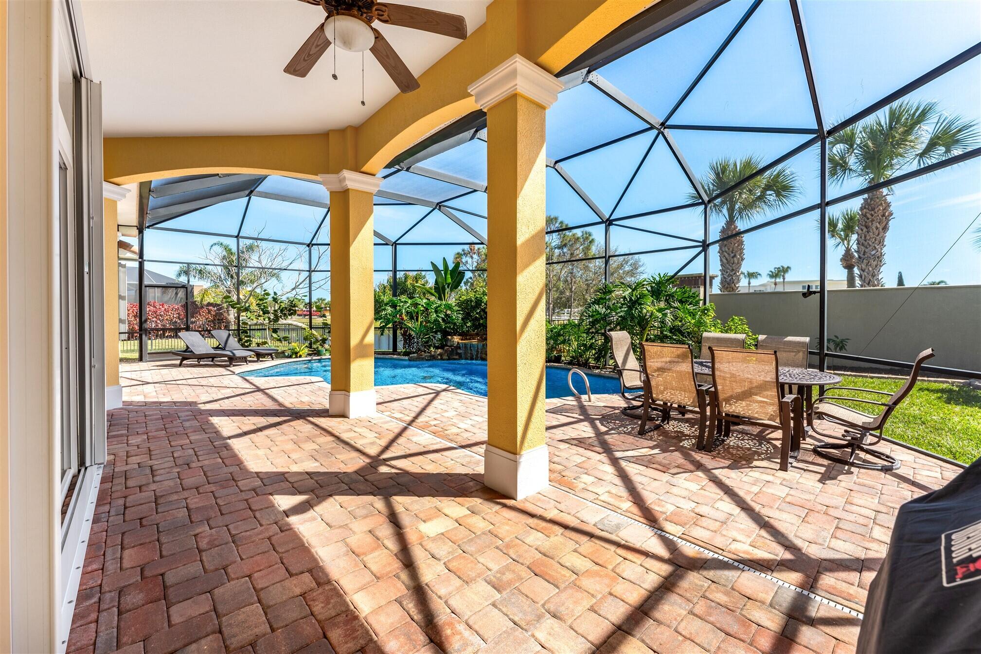 3210 Levanto Drive Melbourne, FL 32940 - Photo 32 of 76 a view of a patio with a dining table and chairs