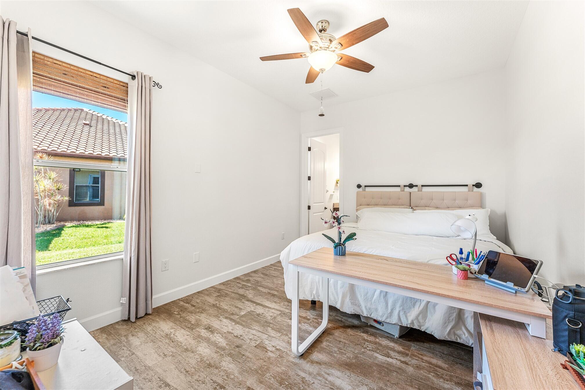 3210 Levanto Drive Melbourne, FL 32940 - Photo 41 of 76 a bedroom with a bed and a chandelier