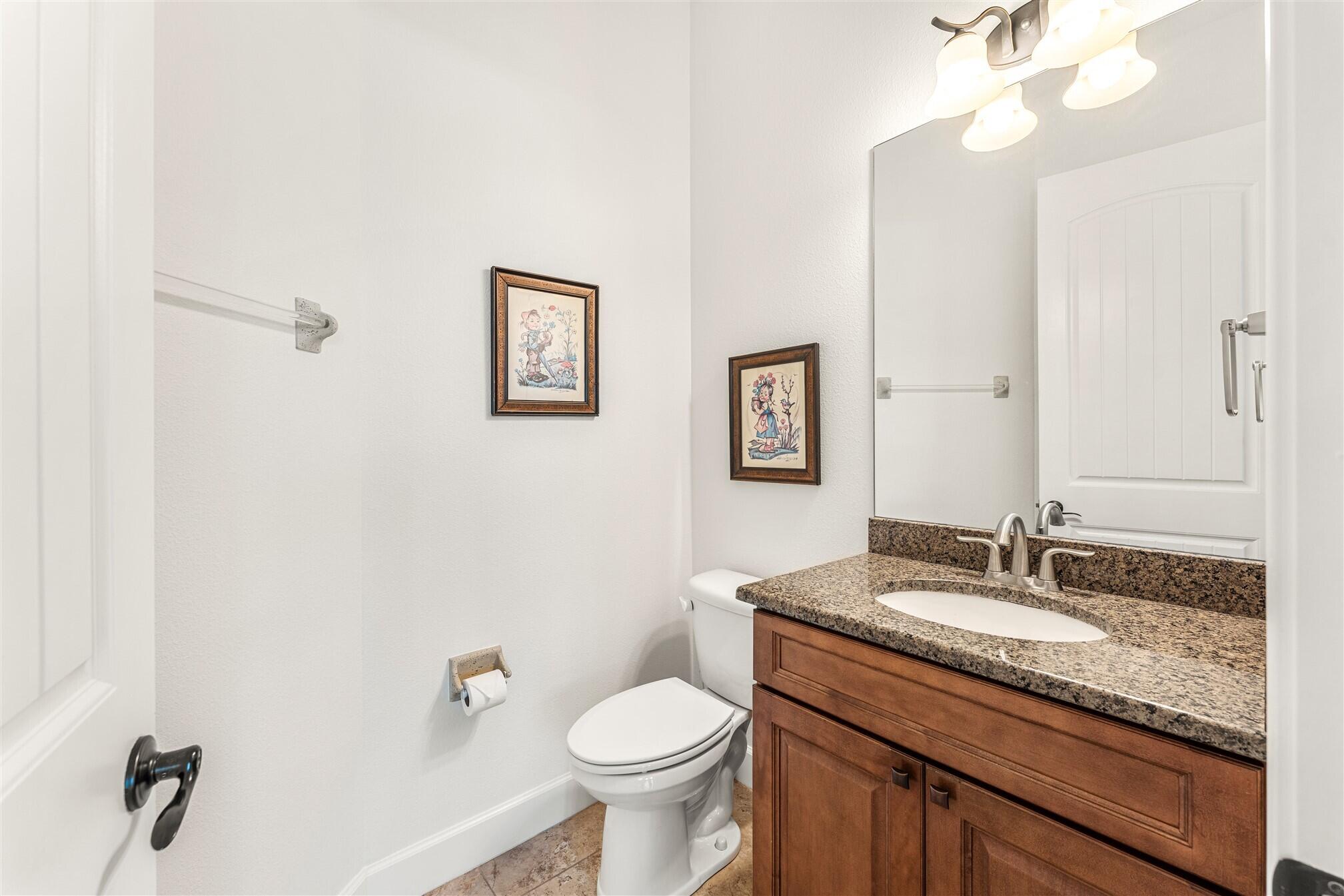 3210 Levanto Drive Melbourne, FL 32940 - Photo 47 of 76 a bathroom with a granite countertop sink toilet and a mirror