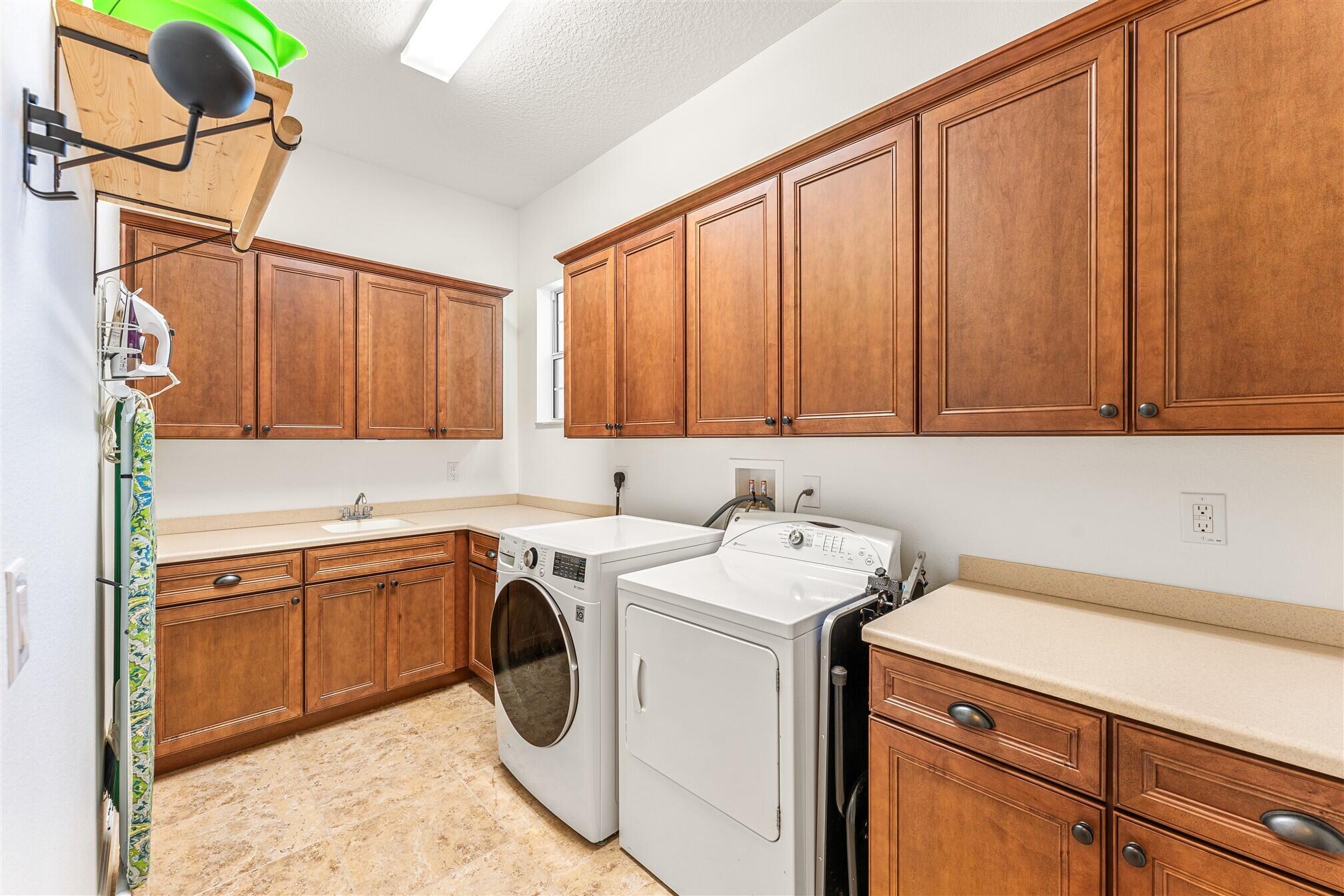 3210 Levanto Drive Melbourne, FL 32940 - Photo 48 of 76 a utility room with dryer and washer